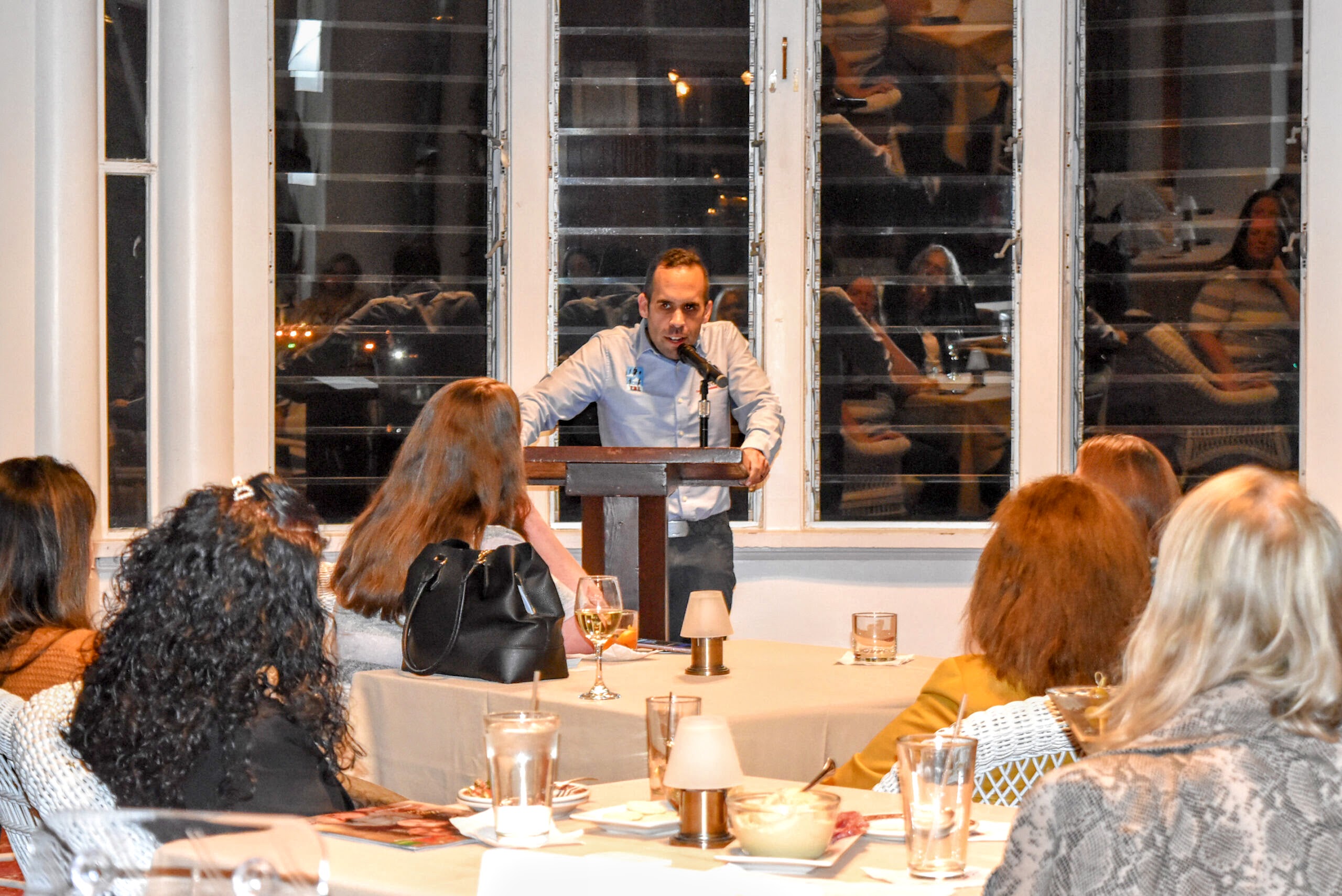 Joshua Luis Pereira speaking at a business networking event